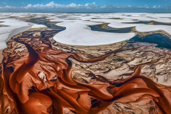 Aerial view of white sand dunes with turquoise lagoons at Lençóis Maranhenses Brazil