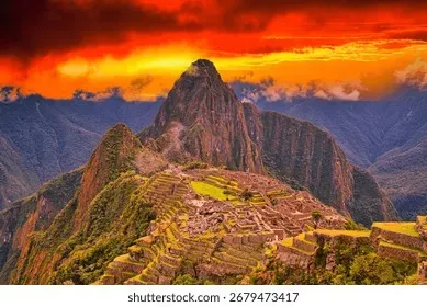 Machu Picchu, Peru at sunset — Inca stone terraces cascading down the mountain ridge under golden light