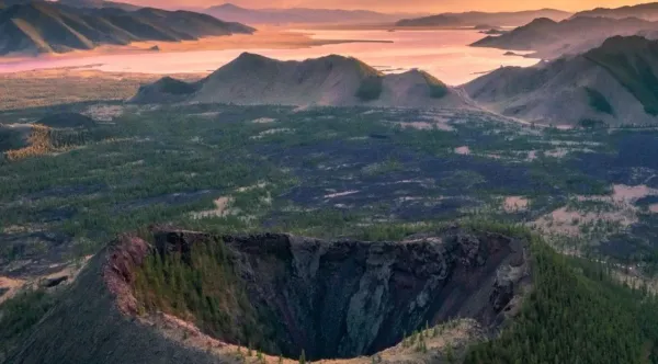 Aerial view of Khorgo Volcano Mongolia crater with Terkhiin Tsagaan Lake and green hills