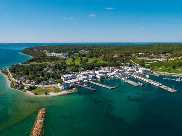 Aerial view of Mackinac Island Michigan with lush green landscapes, charming buildings and marina