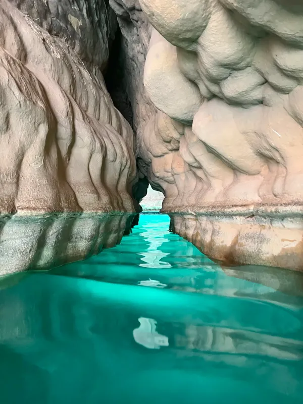 Turquoise pool in Wadi Shab Oman beneath limestone cliffs