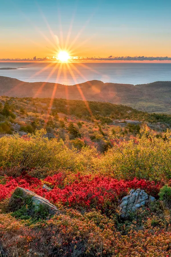 Sunrise over Cadillac Mountain in Acadia National Park United States with colorful autumn foliage