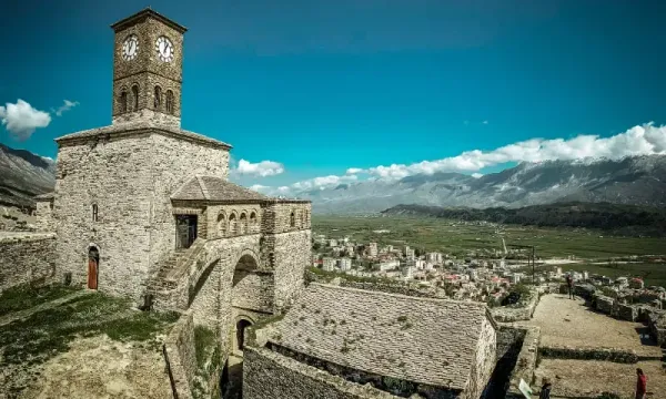 Gjirokastra Castle Albania perched on a hilltop with its iconic clock tower overlooking the valley