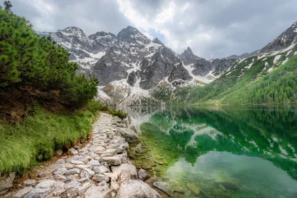 Morskie Oko Poland alpine lake with crystal-clear turquoise water reflecting rugged Tatra Mountain peaks