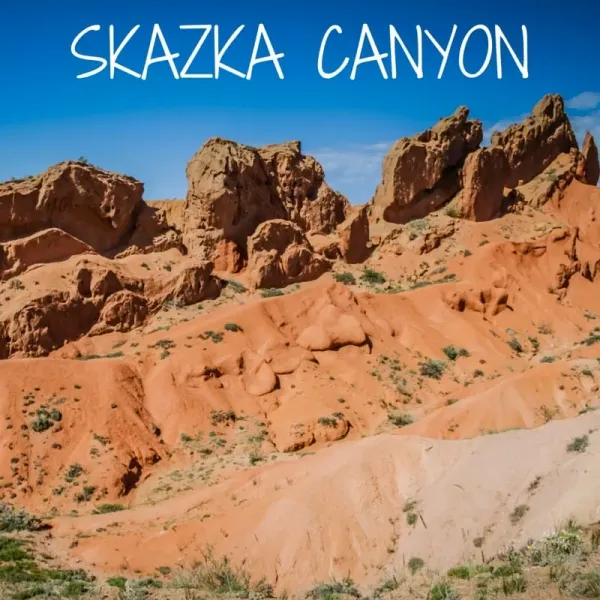 Skazka Canyon Kyrgyzstan panoramic view with red-orange rock formations and Fairy Tale Canyon on the southern shore of Issyk-Kul
