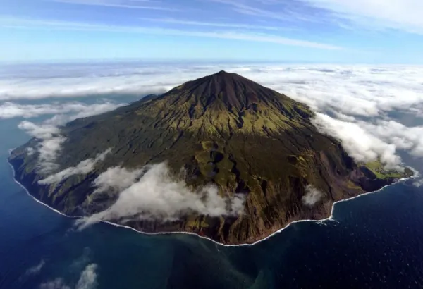 Queen Mary's Peak rising above clouds on Tristan da Cunha, showing its symmetrical volcanic cone