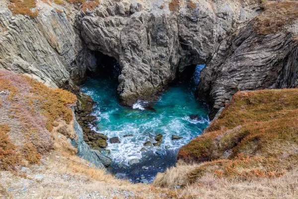Aerial view of The Dungeon Bonavista Newfoundland, a heart-shaped collapsed sea crater with turquoise water inside